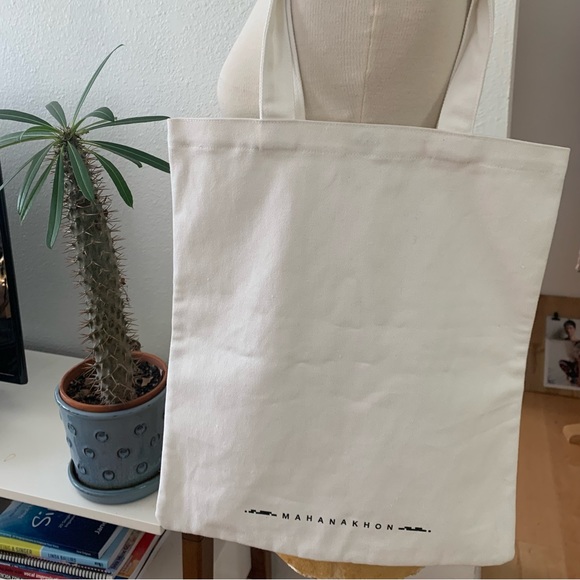 Mahanakhon Tote Bag with green and black font on cream canvas. Pushbutton close - Picture 5 of 6